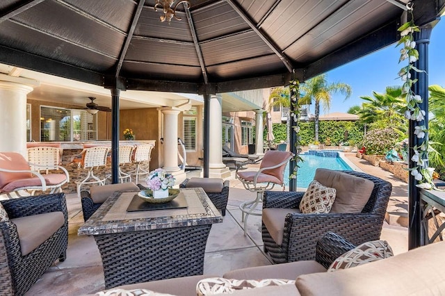 view of patio / terrace featuring a fenced in pool, a gazebo, and an outdoor hangout area