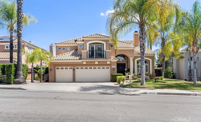 mediterranean / spanish-style house featuring a balcony and a garage