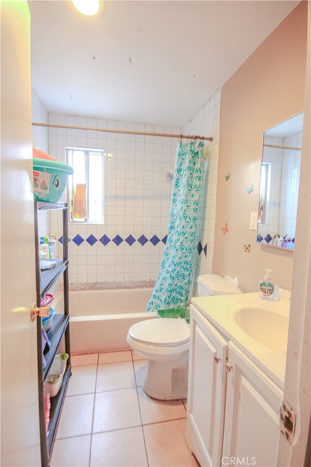 full bathroom featuring tile floors, shower / tub combo with curtain, vanity, and toilet