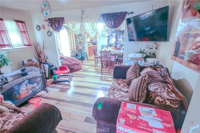 living room with hardwood / wood-style flooring and an inviting chandelier