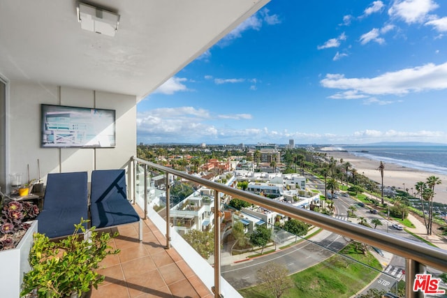 balcony with a beach view and a water view