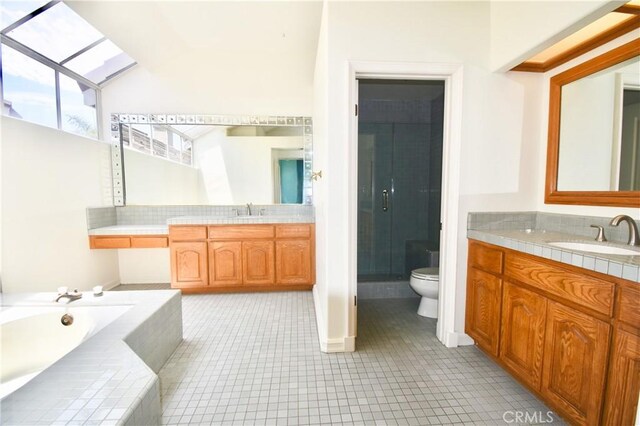 full bathroom featuring plus walk in shower, tile patterned flooring, toilet, and vanity