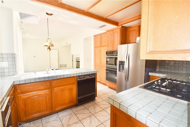 kitchen featuring black appliances, beam ceiling, tile counters, hanging light fixtures, and decorative backsplash