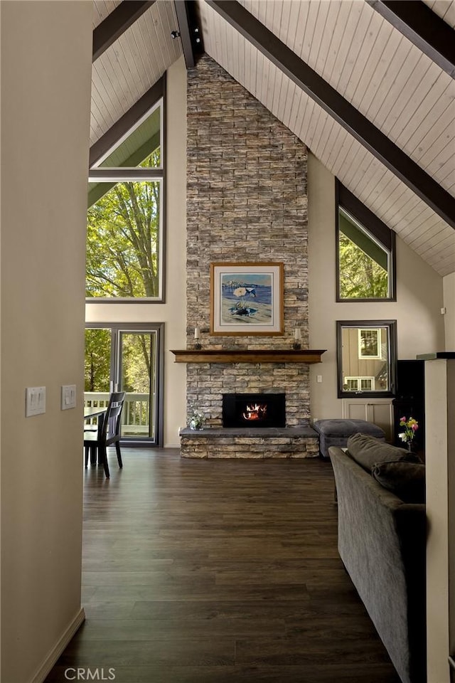 living room with plenty of natural light, dark wood-type flooring, and high vaulted ceiling