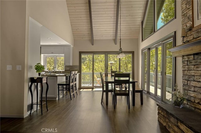 sunroom featuring french doors, vaulted ceiling, a healthy amount of sunlight, and wood ceiling