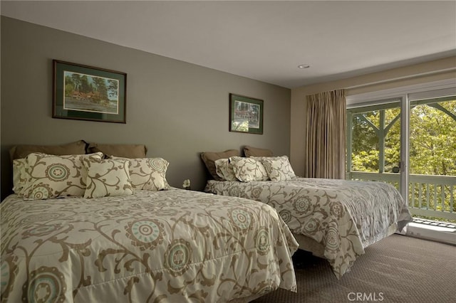 carpeted bedroom featuring access to exterior