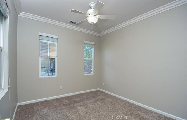 empty room with carpet flooring, ceiling fan, and crown molding