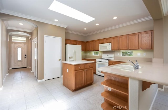 kitchen with kitchen peninsula, white appliances, ornamental molding, and sink