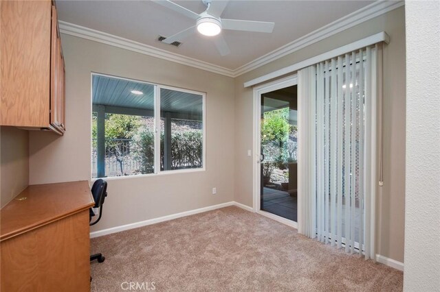 unfurnished office with light carpet, ceiling fan, and ornamental molding