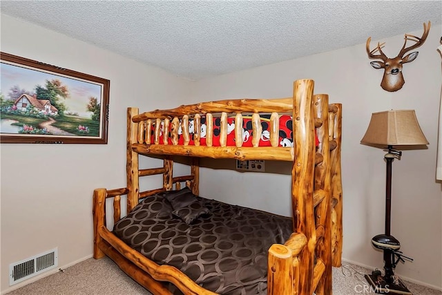 carpeted bedroom with a textured ceiling