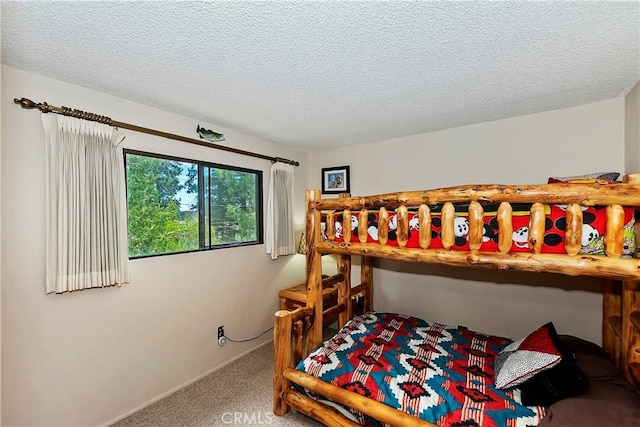 bedroom with carpet flooring and a textured ceiling