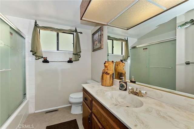 full bathroom with shower / bath combination with glass door, vanity, toilet, and plenty of natural light