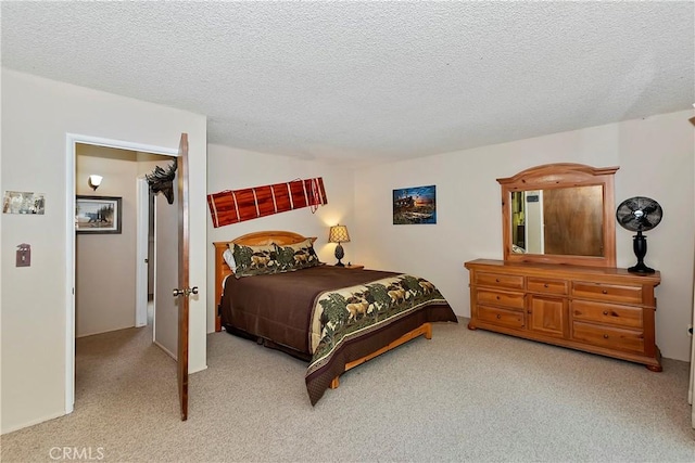 carpeted bedroom featuring a textured ceiling