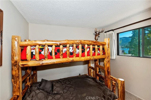 carpeted bedroom featuring a textured ceiling