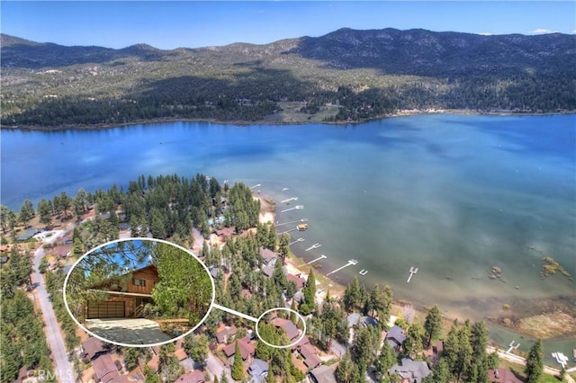 aerial view featuring a water and mountain view