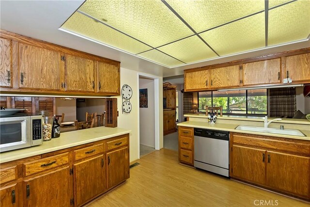 kitchen featuring sink, stainless steel appliances, and light hardwood / wood-style flooring