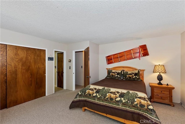 bedroom featuring carpet and a textured ceiling