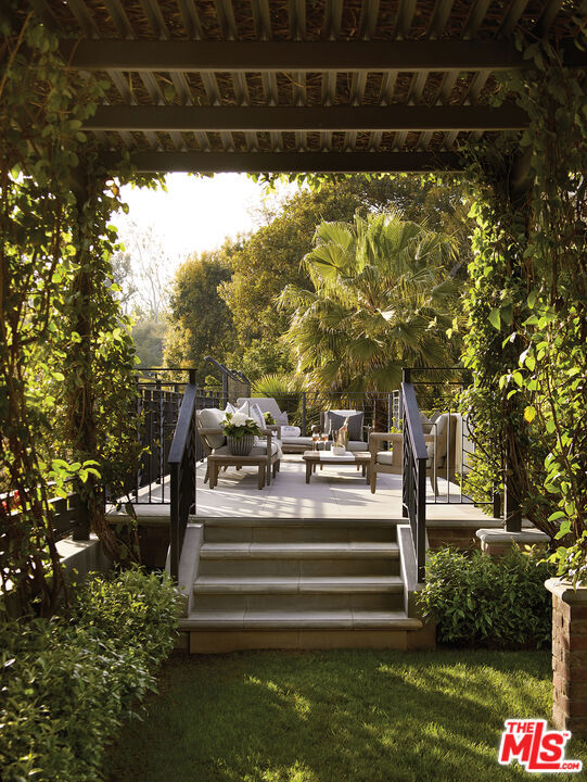 deck featuring a lawn, an outdoor living space, and a gazebo