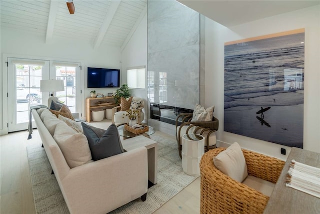 living room with wood ceiling, high vaulted ceiling, light wood-type flooring, ceiling fan, and beam ceiling