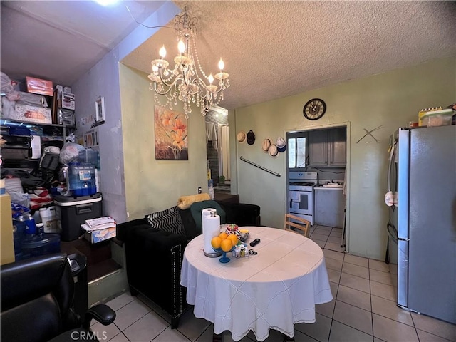 dining room featuring a textured ceiling, light tile patterned floors, and a notable chandelier