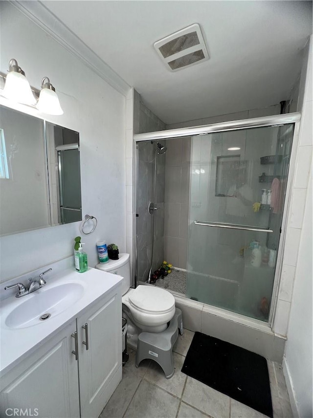 bathroom featuring vanity, tile patterned floors, visible vents, and a stall shower