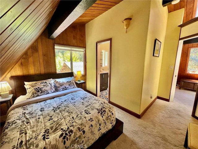 carpeted bedroom featuring connected bathroom, multiple windows, wood walls, and wooden ceiling