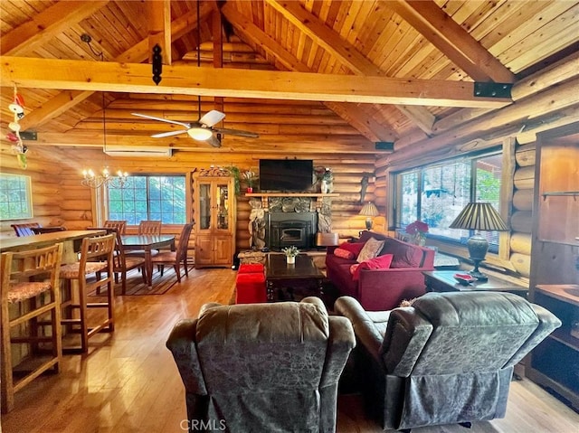 living room featuring light wood-type flooring, rustic walls, ceiling fan with notable chandelier, wooden ceiling, and vaulted ceiling with beams