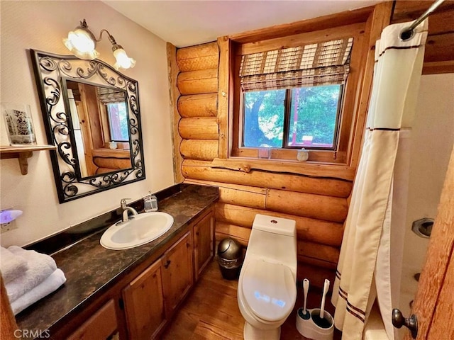 bathroom featuring vanity, a shower with shower curtain, toilet, log walls, and wood-type flooring