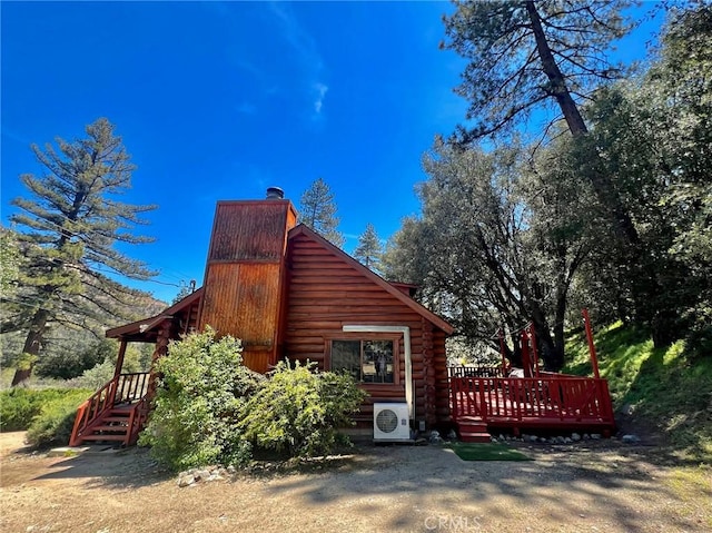 view of property exterior with a wooden deck