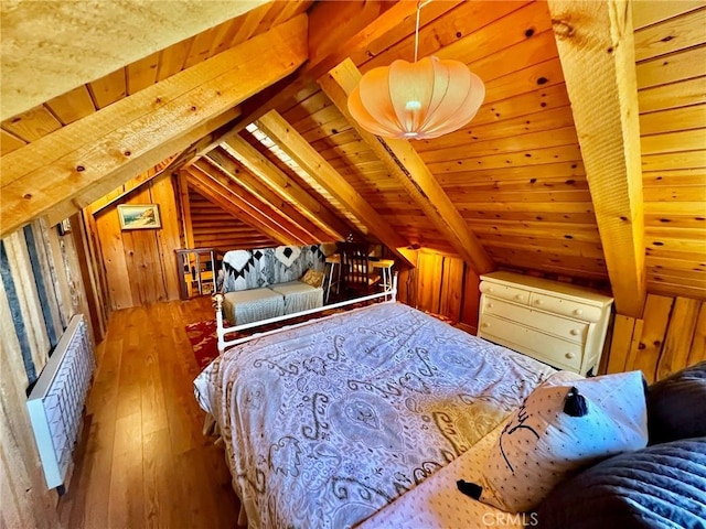 bedroom with hardwood / wood-style flooring, vaulted ceiling with beams, wood walls, and radiator heating unit