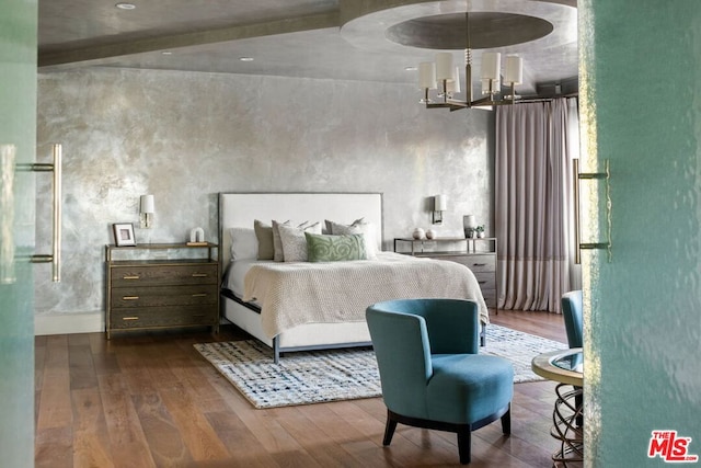 bedroom with dark hardwood / wood-style floors and a chandelier