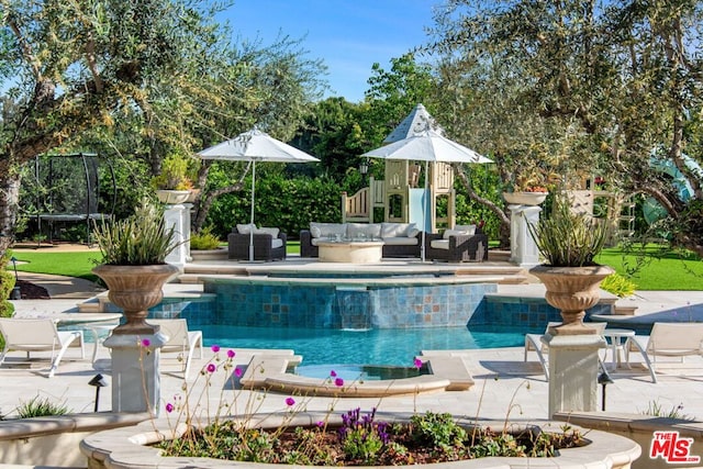 view of pool featuring an outdoor living space and a patio area