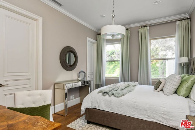 bedroom with hardwood / wood-style flooring and ornamental molding