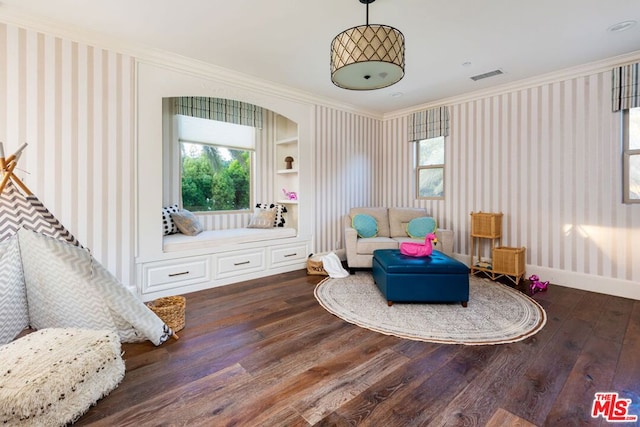 living area featuring hardwood / wood-style flooring, crown molding, and built in features