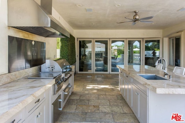 view of patio featuring ceiling fan, sink, and an outdoor kitchen