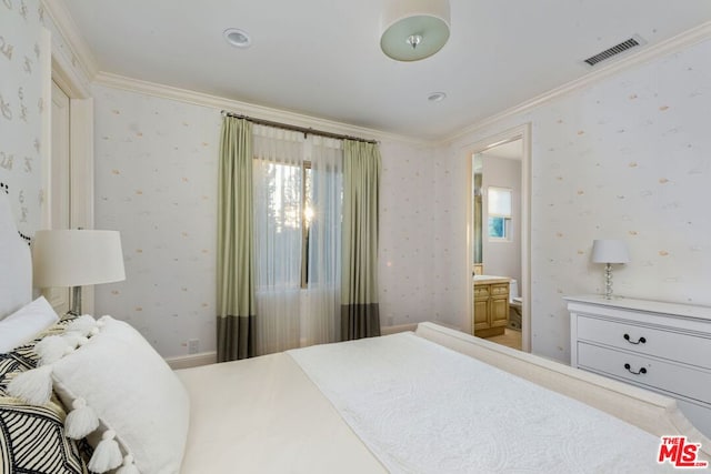 bedroom featuring ensuite bathroom and ornamental molding