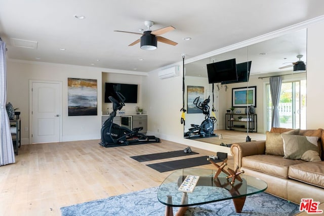 living room featuring ceiling fan, ornamental molding, light wood-type flooring, and a wall unit AC