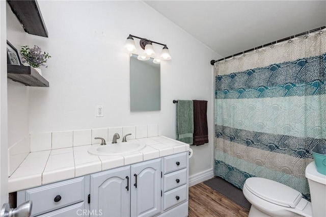 bathroom with curtained shower, vanity, wood-type flooring, and toilet