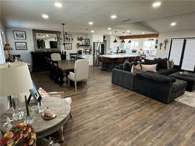 living room featuring dark wood-type flooring and vaulted ceiling