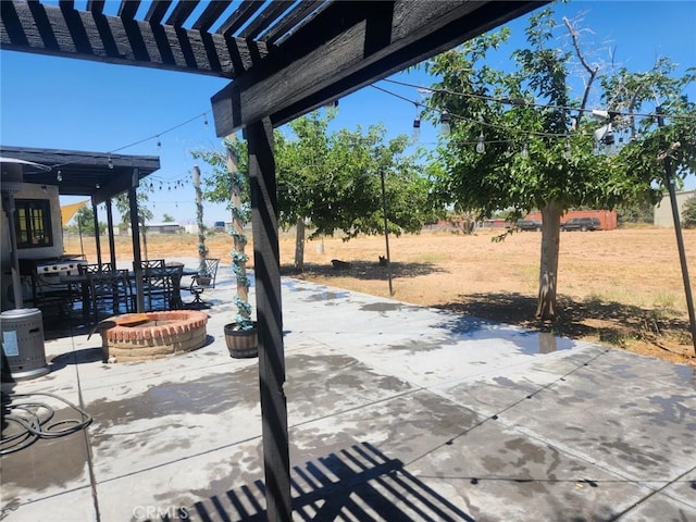 view of patio / terrace with an outdoor fire pit