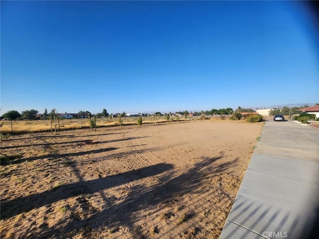 view of yard with a rural view