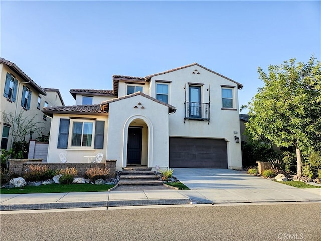 mediterranean / spanish-style home with a garage