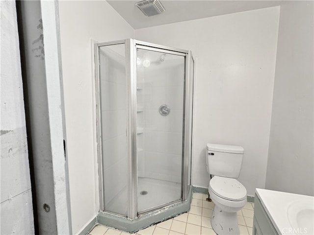 bathroom featuring vanity, toilet, tile patterned flooring, and walk in shower