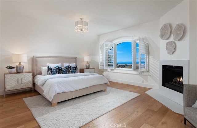 bedroom featuring hardwood / wood-style flooring and an inviting chandelier