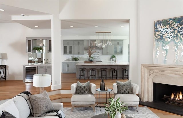 interior space featuring light hardwood / wood-style floors, sink, and beverage cooler