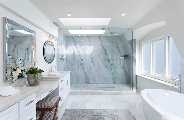 bathroom with vanity, independent shower and bath, and a skylight