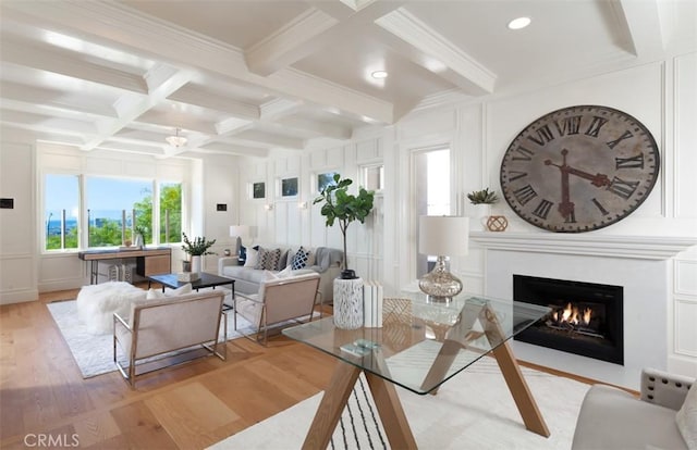 living room featuring beamed ceiling, light hardwood / wood-style floors, crown molding, and coffered ceiling