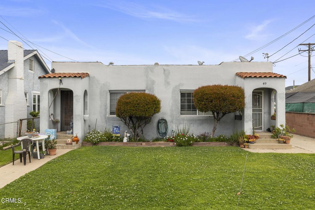 mediterranean / spanish-style home with a front yard