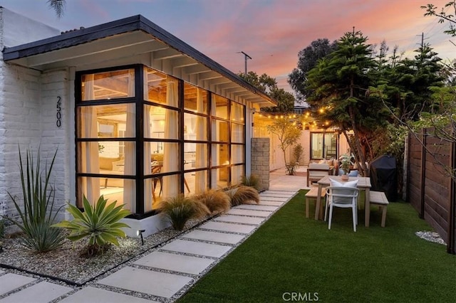 exterior space with a patio area and a lawn