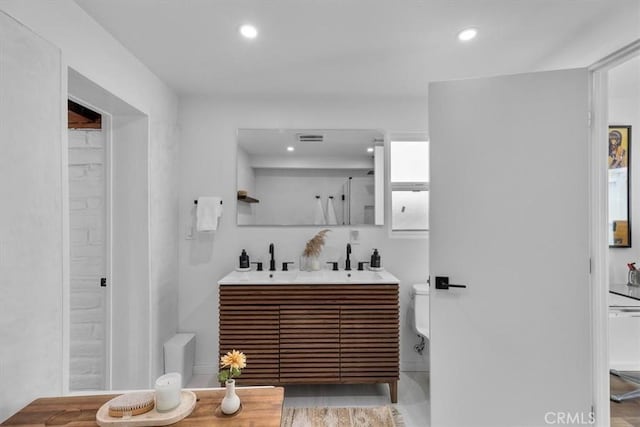 bathroom featuring toilet and vanity